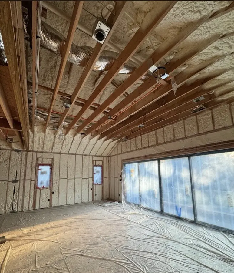 Interior walls and ceiling insulated with spray foam during new construction in Cornwall
